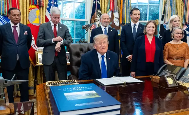 President Donald Trump winks as the members of the media depart the Oval Office of the White House as Essar Capital Director Prashant Ruia, from left, Energy Secretary Chris Wright, Commerce Secretary Howard Lutnick, John Jovanovic, chairman of the Export-Import Bank of the United States, Iowa Attorney General Brenna Bird, Mariannette Miller-Meeks, R-Iowa., and Rep. Ashley Hinson, R-Iowa, look on, Monday, Sept. 28, 2026, in Washington. (AP Photo/Alex Brandon)