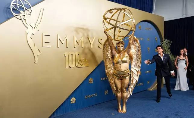 Meg Stalter, left, and Paul W. Downs arrive at the 78th Emmy Awards on Monday, Sept. 14, 2026, at the Peacock Theater in Los Angeles. (AP Photo/Mark J. Terrill)