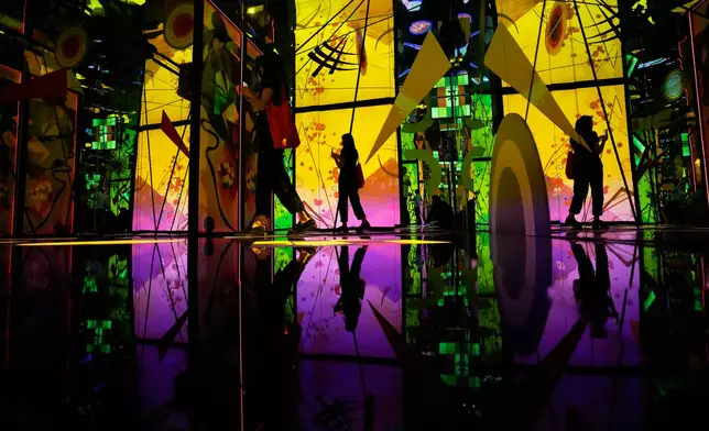 A journalist films a video installation for the exhibition "Kandinsky," a retrospective of Russian painter Wassily Kandinsky, during a press preview at Rome's Palazzo Bonaparte, Monday, Sept. 14, 2026. (AP Photo/Alessandra Tarantino)