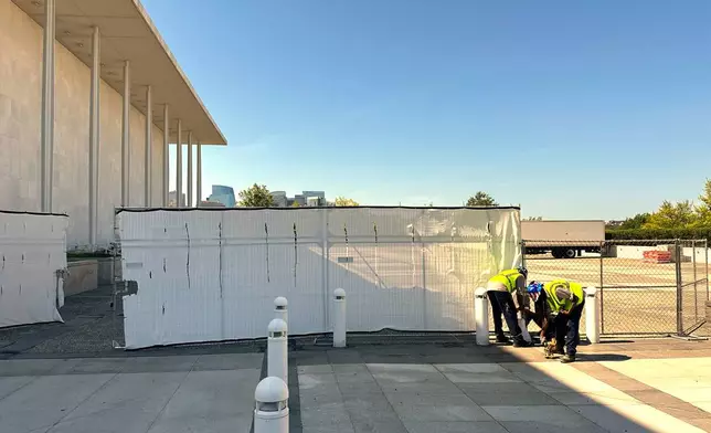 Fencing is placed outside the John F. Kennedy Center for the Performing Arts on Wednesday, Sept. 16, 2026, in Washington. (AP Photo/Nathan Ellgren)