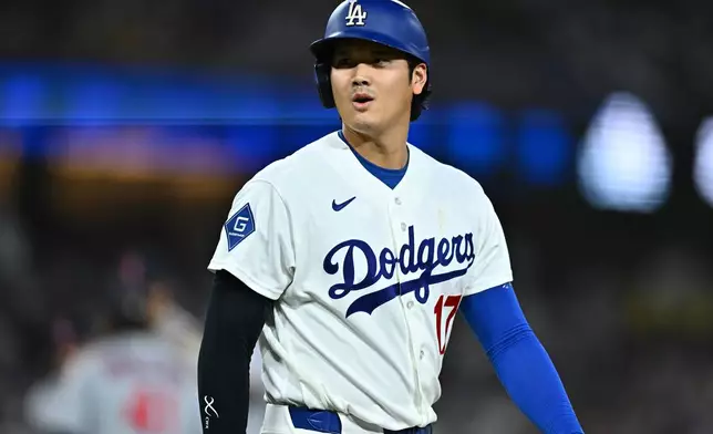 Los Angeles Dodgers' Shohei Ohtani walks to first base after being hit by a pitch during the second inning of a baseball game against the St. Louis Cardinals, Wednesday, Sept. 2, 2026, in Los Angeles. (AP Photo/William Liang)