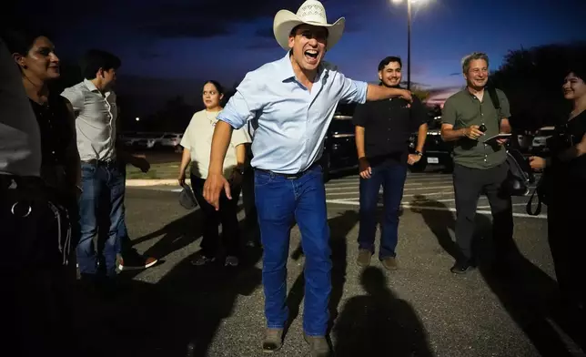 FILE - Democratic candidate for congress Bobby Pulido laughs while speaking with reporters and staff members in the parking lot of Richard R. Flores Stadium, before attending a football game between Edcouch-Elsa High School and Robert Vela High School, Thursday, Sept. 17, 2026, in Edinburg, Texas. (AP Photo/Julia Demaree Nikhinson,File)