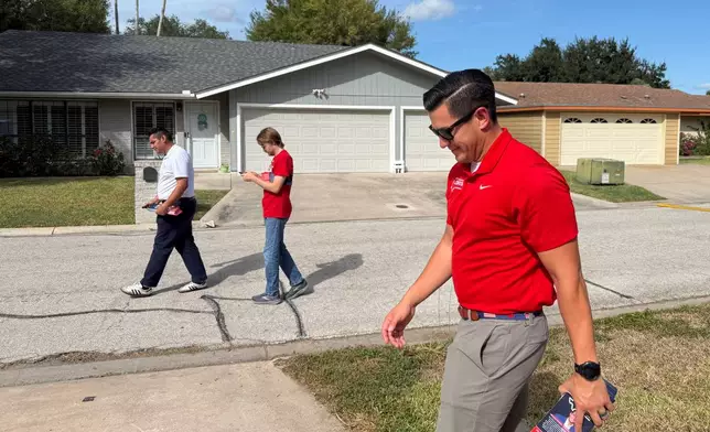 This photo taken with a smartphone shows Republican U.S. House candidate Eric Flores door knocks on Sunday, Sept. 18, 2026, in Harlingen, Texas. (AP Photo/Jesse Bedayn)