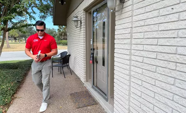 This photo taken with a smartphone shows Republican U.S. House candidate Eric Flores door knocks on Sunday, Sept. 18, 2026, in Harlingen, Texas. (AP Photo/Jesse Bedayn)