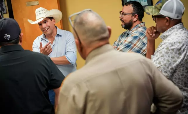 Democratic candidate for congress Bobby Pulido, second from left, attends a football game between Edcouch-Elsa High School and Robert Vela High School, Thursday, Sept. 17, 2026, at Richard R. Flores Stadium in Edinburg, Texas. (AP Photo/Julia Demaree Nikhinson)