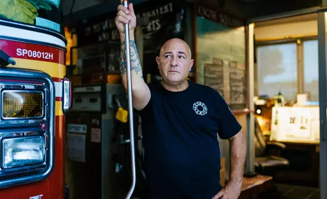 Firefighter Sal Argano, Ladder 10, poses for a portrait at FDNY "Ten House" near Ground Zero on Friday, Aug. 7, 2026, in New York. (AP Photo/Angelina Katsanis)