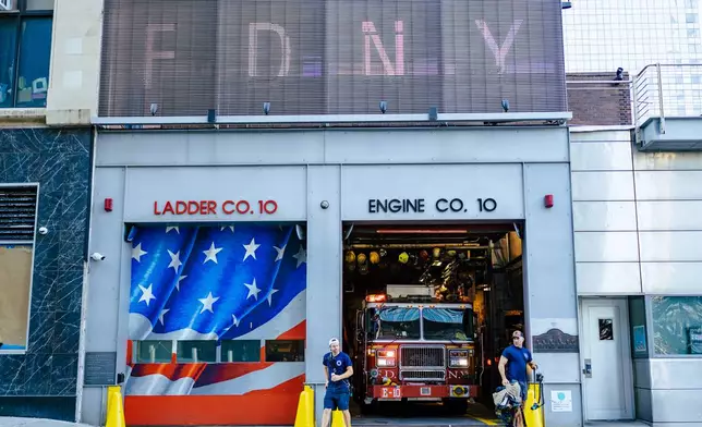 FDNY "Ten House" firefighters work near Ground Zero, 25 years after the Sept. 11, 2001, attacks, on Friday, Aug. 7, 2026 in New York. (AP Photo/Angelina Katsanis)