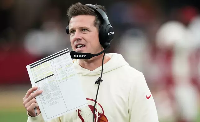Arizona Cardinals head coach Mike LaFleur talks into his headset during the second half of an NFL football game against the Seattle Seahawks in Glendale, Ariz., Sunday, Sept. 20, 2026. (AP Photo/Ross D. Franklin)