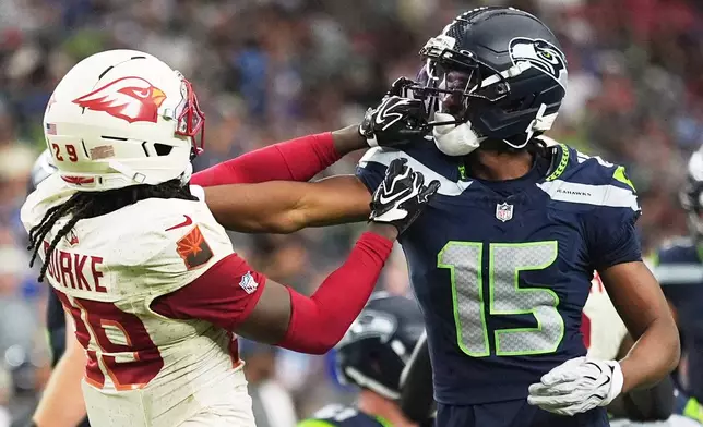 Arizona Cardinals cornerback Denzel Burke (29) and Seattle Seahawks wide receiver Tory Horton (15) shove each other during a play during the second half of an NFL football game in Glendale, Ariz., Sunday, Sept. 20, 2026. (AP Photo/Ross D. Franklin)