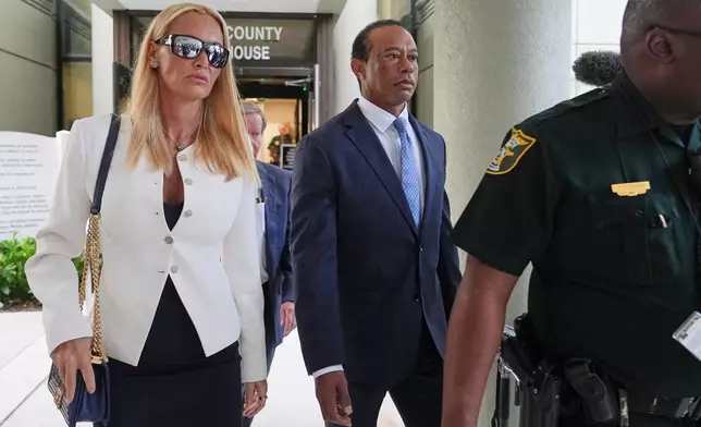 Golfer Tiger Woods, right, leaves with Vanessa Trump, left, after Woods' plea conference hearing in a DUI case stemming from a rollover crash in Florida in March, Wednesday, Sept. 2, 2026, in Stuart, Fla. (AP Photo/Lynne Sladky)