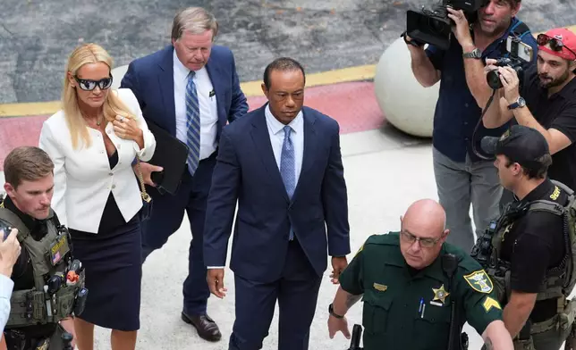 Golfer Tiger Woods, right, arrives with Vanessa Trump, left, for Woods' plea conference hearing in a DUI case stemming from a rollover crash in Florida in March, Wednesday, Sept. 2, 2026, in Stuart, Fla. (AP Photo/Rebecca Blackwell)