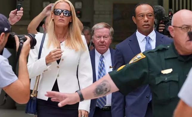 Golfer Tiger Woods, right, leaves with Vanessa Trump, left, after Woods' plea conference hearing in a DUI case stemming from a rollover crash in Florida in March, Wednesday, Sept. 2, 2026, in Stuart, Fla. (AP Photo/Rebecca Blackwell)