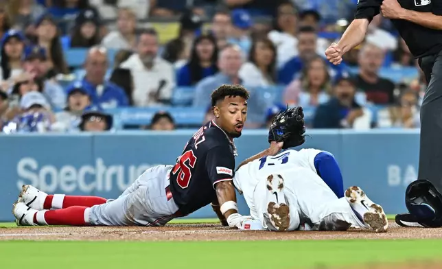 Washington Nationals' Nasim Nuñez, left, is caught by Los Angeles Dodgers third baseman Max Muncy (13) while trying to steal third base during the third inning of a baseball game Friday, Sept. 4, 2026, in Los Angeles. (AP Photo/William Liang)