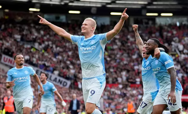 Manchester City's Erling Haaland celebrates after scoring his sides first goal during the English Premier League soccer match against Manchester United in Manchester, England, Sunday Sept. 13, 2026. (Peter Byrne/PA via AP)