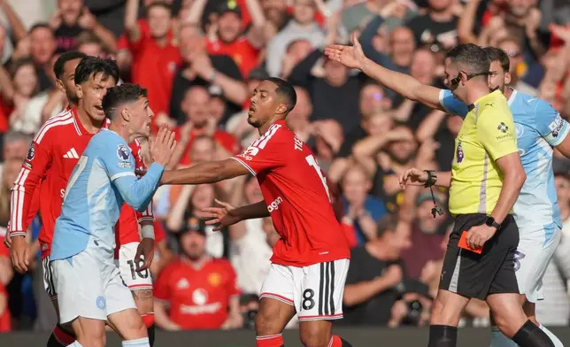 Referee Michael Oliver shows a red card to Manchester City's Phil Foden during the English Premier League soccer match between Manchester United and Manchester City in Manchester, England, Sunday, Sept. 13, 2026. (AP Photo/Ian Hodgson)