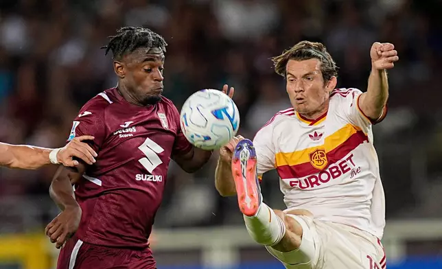 Roma's Marten De Roon, right, and Torino's Duvan Zapata challenge for the ball during the Serie A soccer match between FC Torino and AS Roma in Turin, Italy, Monday, Sept. 14, 2026. (Marco Alpozzi/LaPresse via AP)