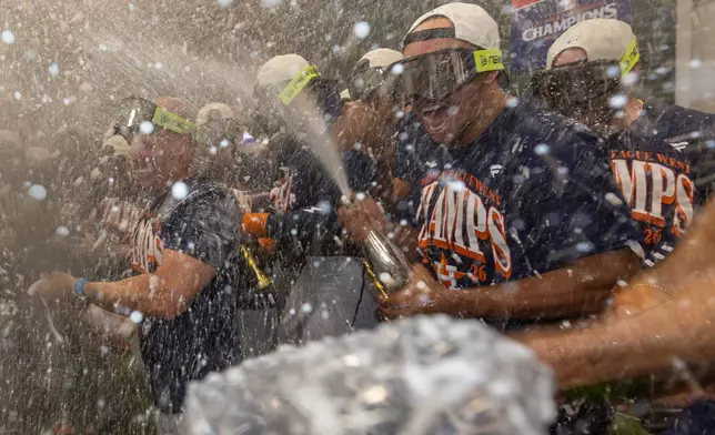 Houston Astros celebrate after clinching the AL West division title in a baseball game against the Athletics, Sunday, Sept. 27, 2026, in West Sacramento, Calif. (AP Photo/Sara Nevis)