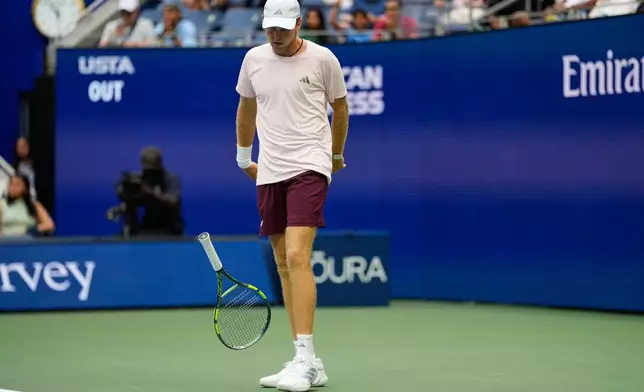 Alex Michelsen, of the United States, slams his racket during a match against Frances Tiafoe, of the United States, during the quarterfinal round of the U.S. Open tennis championships, Tuesday, Sept. 8, 2026, in New York. (AP Photo/Seth Wenig)