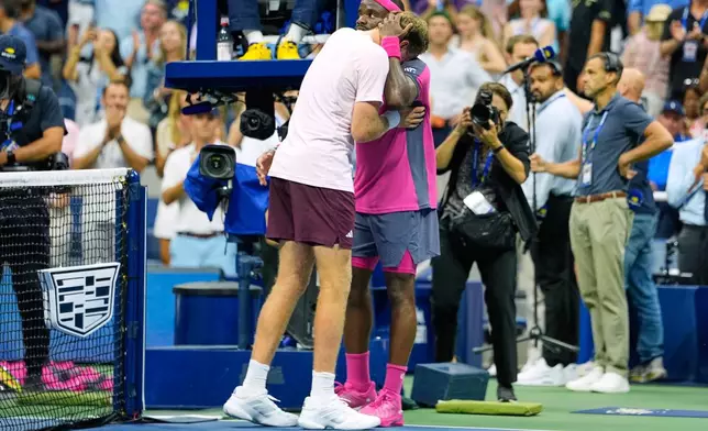 Frances Tiafoe, of the United States, right, and Alex Michelsen, of the United States, embrace after Tiafoe won their match during the quarterfinal round of the U.S. Open tennis championships, Tuesday, Sept. 8, 2026, in New York. (AP Photo/Seth Wenig)