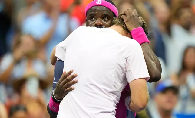 Frances Tiafoe, of the United States, right, and Alex Michelsen, of the United States, embrace after Tiafoe won their match during the quarterfinal round of the U.S. Open tennis championships, Tuesday, Sept. 8, 2026, in New York. (AP Photo/Yuki Iwamura)