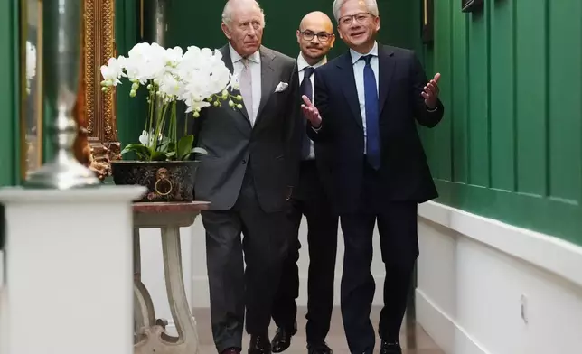 Britain's King Charles III, left, walks with Nvidia chief executive Jensen Huang, right, and Sir Demis Hassabis to a meeting for leaders from the artificial intelligence (AI) sector, government, and thought leaders to discuss how AI can be developed and deployed in ways that benefit society, at Dumfries House in Cumnock, Scotland, Thursday Sept. 17, 2026. (Jonathan Brady/PA via AP, Pool)