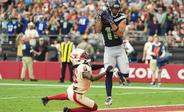 Seattle Seahawks wide receiver Jaxon Smith-Njigba (11) makes a touchdown catch against Arizona Cardinals cornerback Max Melton, left, during the second half of an NFL football game in Glendale, Ariz., Sunday, Sept. 20, 2026. (AP Photo/Ross D. Franklin)