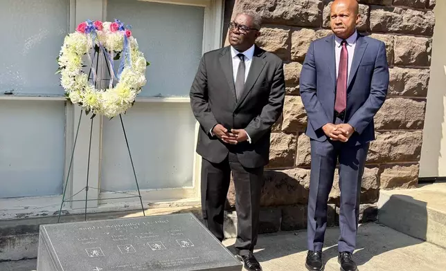 This photo taken with a smartphone shows Rev. Arthur Price, Jr., left, and Bryan Stevenson, the founder and executive director of the Equal Justice Initiative, attending a commemoration service in honor of the 63rd anniversary of the church's bombing at 16th Street Baptist Church in Birmingham, Ala., Tuesday, Sept. 15, 2026. (AP Photo/Kim Chandler)