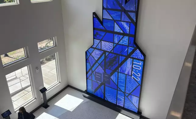 This photo taken with a smartphone shows a person standing inside the visitor and education center at 16th Street Baptist Church in Birmingham, Ala., Tuesday, Sept. 15, 2026. (AP Photo/Kim Chandler)