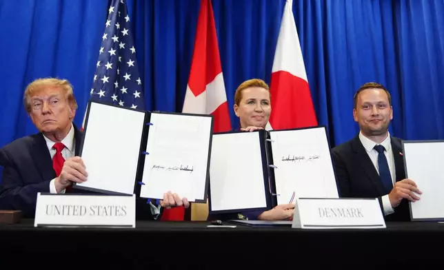 President Donald Trump signs a security agreement with Denmark's Prime Minister Mette Frederiksen and Greenland's Prime Minister Jens-Frederik Nielsen during the United Nations General Assembly, Tuesday, Sept. 22, 2026, at the UN headquarters. (AP Photo/Julia Demaree Nikhinson)