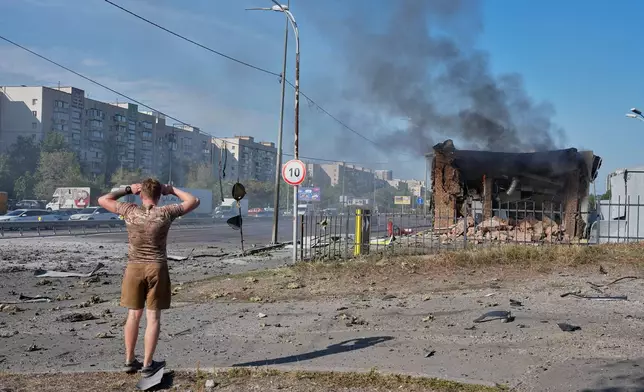 A civilian reacts after a gas station was hit by a Russian drone in Kyiv, Ukraine, Friday, Sept. 11, 2026. (AP Photo/Efrem Lukatsky)