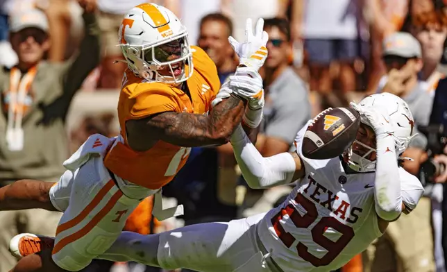 Texas defensive back Graceson Littleton (29) breaks up a pass intended for Tennessee tight end Ethan Davis (0) during the first half of an NCAA college football game, Saturday, Sept. 26, 2026, in Knoxville, Tenn. (AP Photo/Wade Payne)