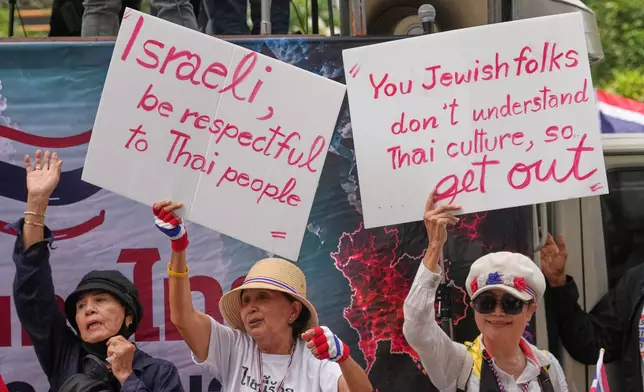 Protesters holding signs attend a demonstration demanding an end to alleged land-grabbing by foreigners, in front of Israeli Embassy in Bangkok, Thailand, Thursday, Sept. 10, 2026. (AP Photo/Sakchai Lalit)