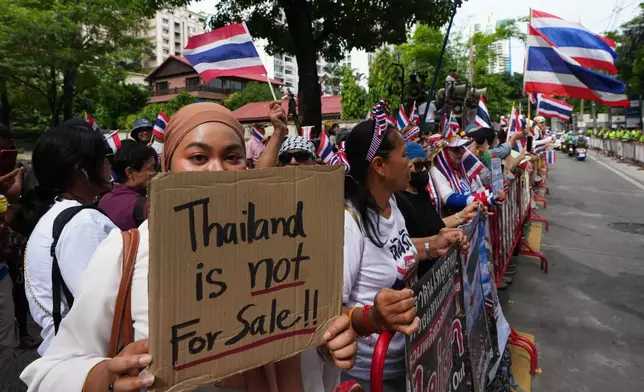 Protesters holding signs attend a demonstration demanding an end to alleged land-grabbing by foreigners, in front of Israeli Embassy in Bangkok, Thailand, Thursday, Sept. 10, 2026. (AP Photo/Sakchai Lalit)