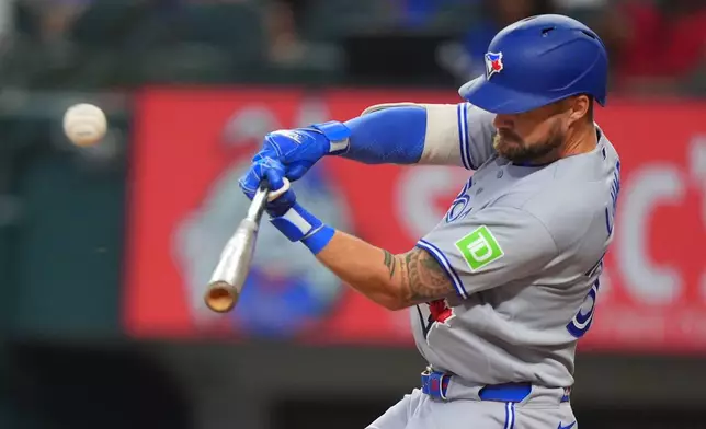 Toronto Blue Jays' Nathan Lukes hits a sacrifice flyout which scored teammate Brett Bateman during the first inning of a baseball game against the Texas Rangers, Sunday, Sept. 20, 2026, in Arlington, Texas. (AP Photo/LM Otero)