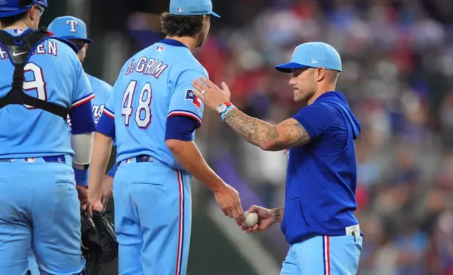 Texas Rangers starting pitcher Jacob deGrom (48) is pulled by Texas Rangers manger Skip Schumaker, right, during the fifth inning of a baseball game against the Toronto Blue Jays, Sunday, Sept. 20, 2026, in Arlington, Texas. (AP Photo/LM Otero)