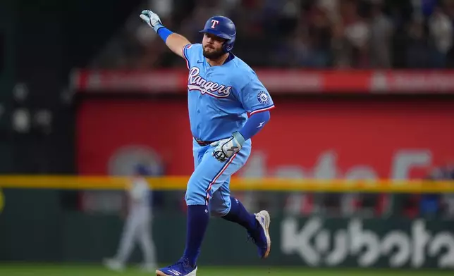 Texas Rangers' Jake Burger runs the bases after hitting a home run during the fourth inning of a baseball game against the Toronto Blue Jays, Sunday, Sept. 20, 2026, in Arlington, Texas. (AP Photo/LM Otero)
