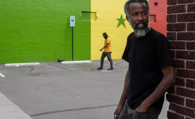 Moussa Sow, a Mauritanian immigrant, stands at the parking lot of Touba Tedoungal African restaurant in Lockland, Ohio, Friday, July 31, 2026. (AP Photo/Carolyn Kaster)