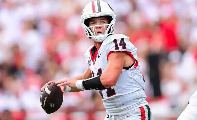 Georgia quarterback Gunner Stockton (14) looks to throw during the first half of an NCAA college football game against Western Kentucky, Saturday, Sept. 12, 2026, in Athens, Ga. (AP Photo/Colin Hubbard)