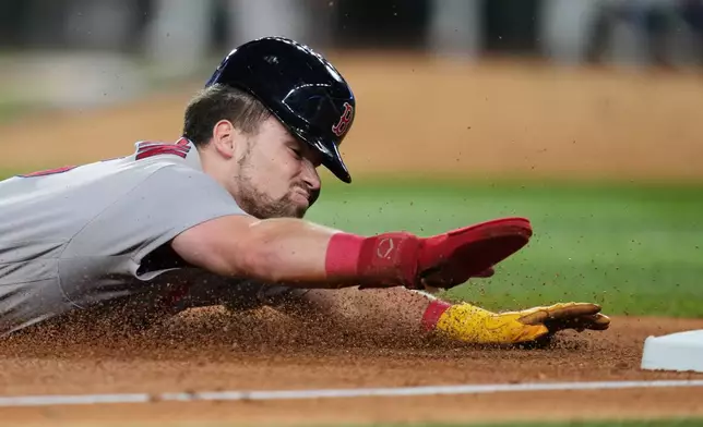 Boston Red Sox's Caleb Durbin advances to third on a single by Trevor Story in the fifth inning of a baseball game against the Texas Rangers Wednesday, Sept. 16, 2026, in Arlington, Texas. (AP Photo/Tony Gutierrez)