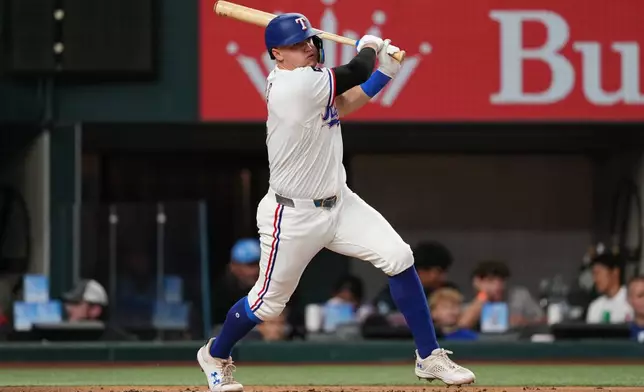 Texas Rangers' Josh Jung follows through on a single in the first inning of a baseball game against the Boston Red Sox Wednesday, Sept. 16, 2026, in Arlington, Texas. (AP Photo/Tony Gutierrez)
