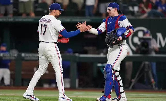 Texas Rangers pitcher Nathan Eovaldi (17) and catcher Danny Jansen, right, celebrate the team's win in a baseball game against the Boston Red Sox Wednesday, Sept. 16, 2026, in Arlington, Texas. (AP Photo/Tony Gutierrez)
