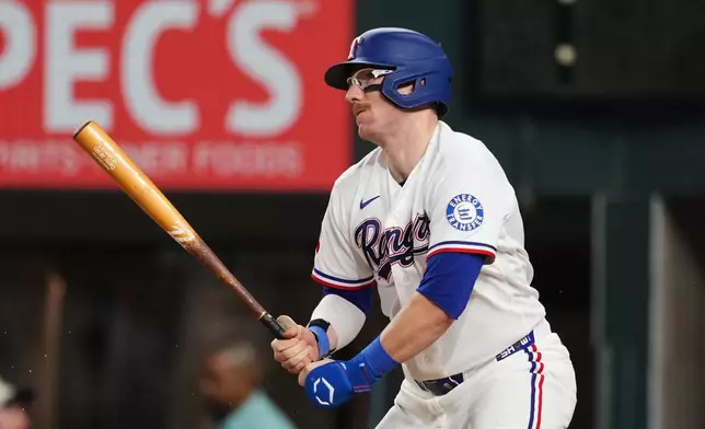 Texas Rangers' Danny Jansen follows through on an infield single in the fourth inning of a baseball game against the Boston Red Sox Wednesday, Sept. 16, 2026, in Arlington, Texas. (AP Photo/Tony Gutierrez)