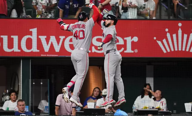 Boston Red Sox's Willson Contreras (40) and Wilyer Abreu, right, celebrate Contreras two-run home run in the first inning of a baseball game against the Texas Rangers Wednesday, Sept. 16, 2026, in Arlington, Texas. (AP Photo/Tony Gutierrez)