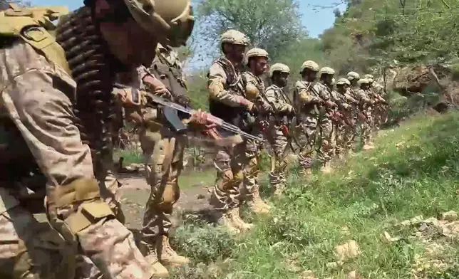 This image taken from undated video released by the Ansar Allah Media Office, the media arm of Yemen's Houthi rebels, on Tuesday, Sept. 22, 2026, shows what the group says are Houthi fighters standing in formation in an area of clashes with Saudi-backed forces in Yemen. (Ansar Allah Media Office via AP)