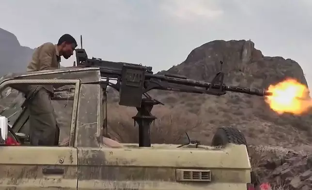This image taken from undated video released by the Ansar Allah Media Office, the media arm of Yemen's Houthi rebels, on Tuesday, Sept. 22, 2026, shows what the group says is a Houthi fighter firing a vehicle-mounted machine gun at Saudi-backed forces in Yemen. (Ansar Allah Media Office via AP)