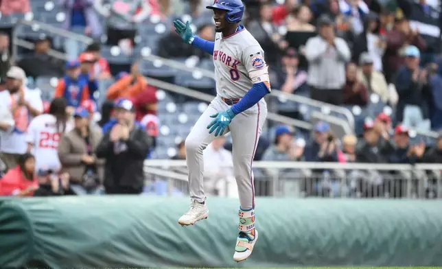 New York Mets' Ronny Mauricio celebrates his two-run home run as he rounds the bases during the ninth inning of a baseball game against the Washington Nationals, Saturday, Sept. 26, 2026, in Washington. (AP Photo/Nick Wass)