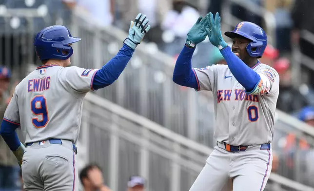 New York Mets' Ronny Mauricio (0) celebrates his two-run home run with A.J. Ewing (9) during the ninth inning of a baseball game against the Washington Nationals, Saturday, Sept. 26, 2026, in Washington. (AP Photo/Nick Wass)
