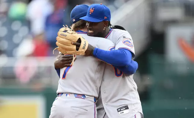 New York Mets second baseman Ronny Mauricio, right, and shortstop Brett Baty, left, embrace after a baseball game against the Washington Nationals, Saturday, Sept. 26, 2026, in Washington. (AP Photo/Nick Wass)