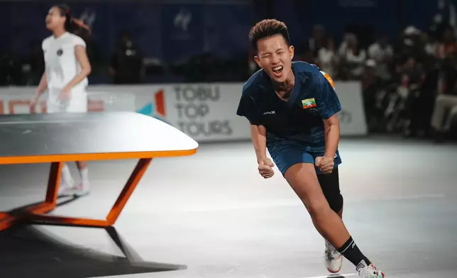 Myanmar's Khin Hnin Wai celebrates after defeating Indonesia's Sumaya to win the gold medal during their women's singles teqball final match at the Asian Games in Nagoya, Japan, Sunday, Sept. 20, 2026. (AP Photo/Lee Jin-man)