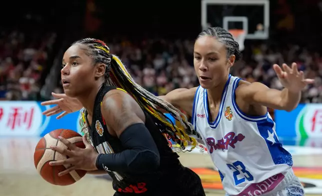 Puerto Rico's Trinity San Antonio guards Belgium's Maxuella Lisowa-Mbaka during the Women's Basketball World Cup match between Puerto Rico and Belgium in Berlin, Sunday, Sept. 6, 2026. (AP Photo/Ebrahim Noroozi)